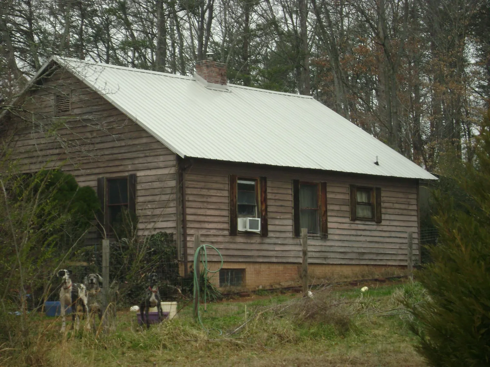 White metal roof on an old wood sided farmhouse, from a Metal Roof Installation job in Trexlertown